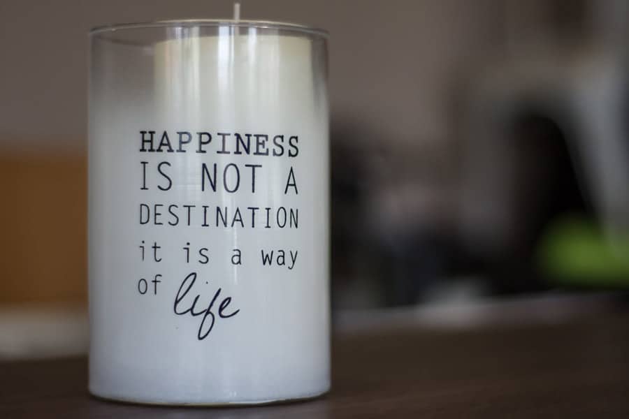 candle in glass with quote